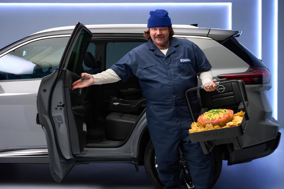 Matty Matheson stepping out of a Nissan vehicle hold a tray of dip.